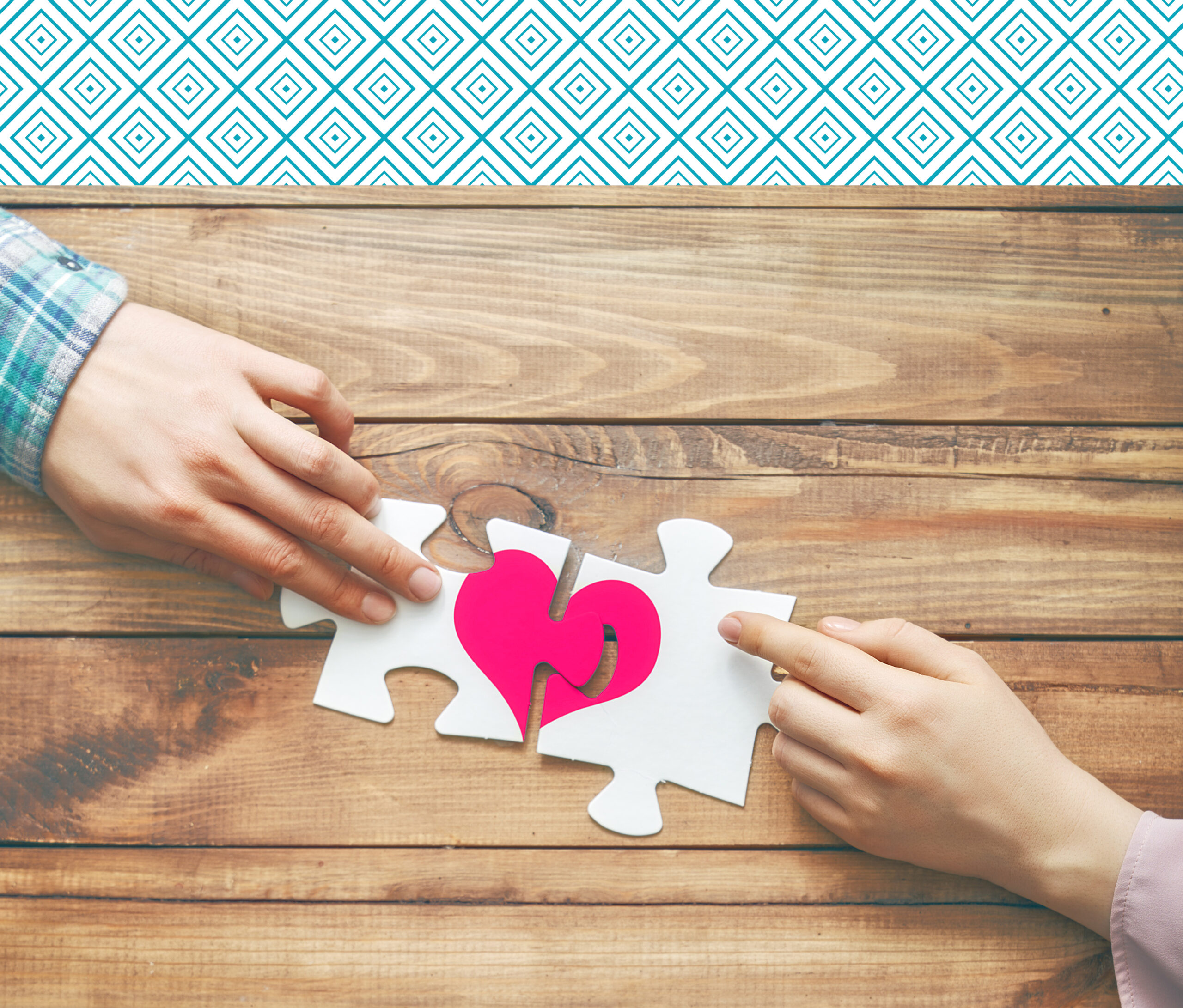 Man and woman put the red heart puzzle together. Concept of Valentine's day.